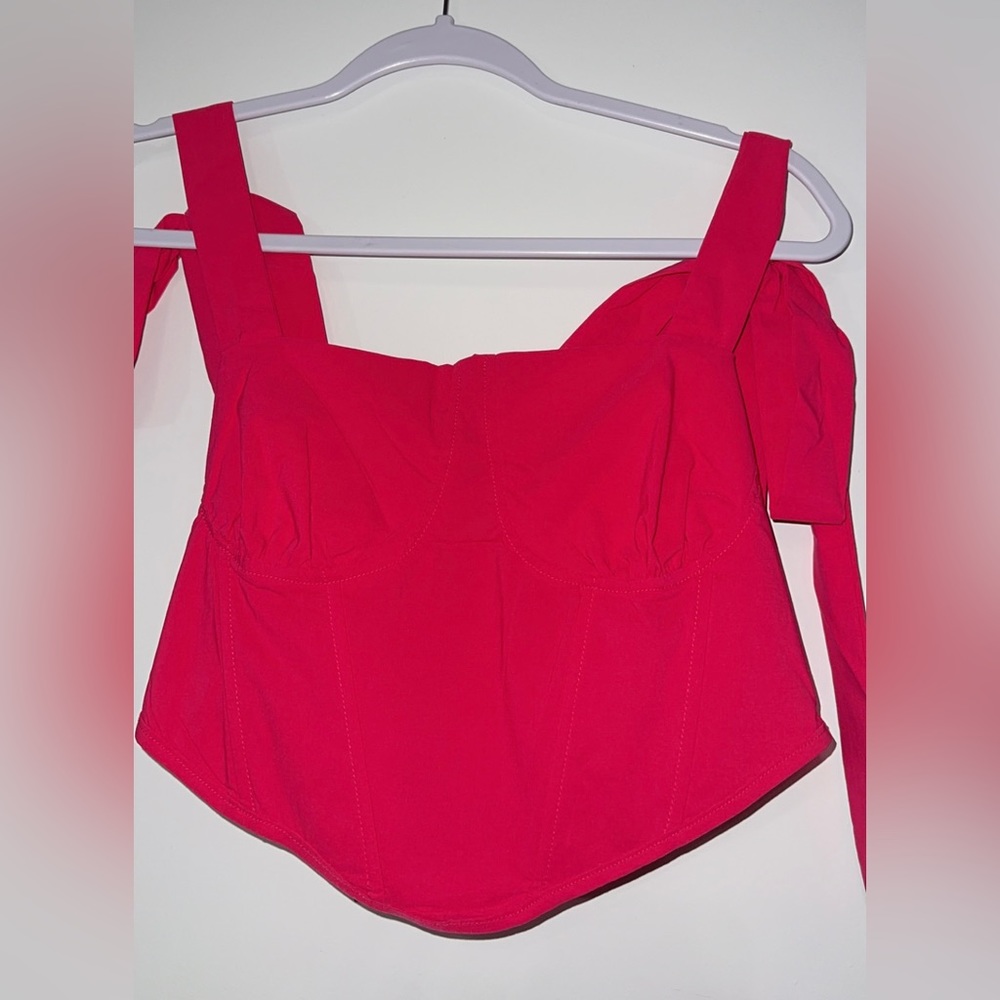 Hot pink bustier crop top with tie up shoulder straps. Never worn.